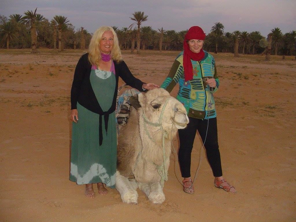 ženy s velbloudem na poušti